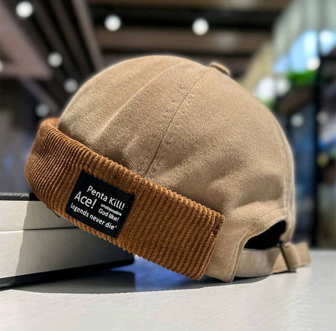 Gorra de estibador con parche de letra y rebite de cordón A25QD010